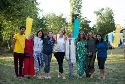 A group of people smiling and posing for a photo outdoors.