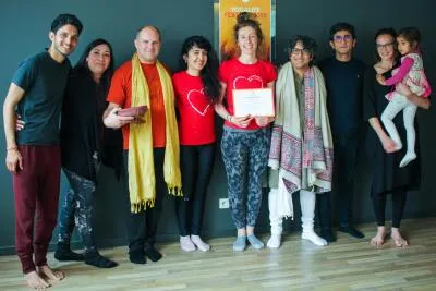 A diverse group of people, including a man, a woman, and a child, posing together for a photo.