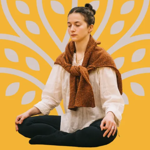 A woman meditating in a cross-legged position