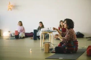 Woman leading a yoga or meditation class